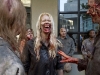 Zombie-accessorized extras socialize on the sidewalk in downtown Atlanta during filming of "The Walking Dead" June 14, 2011